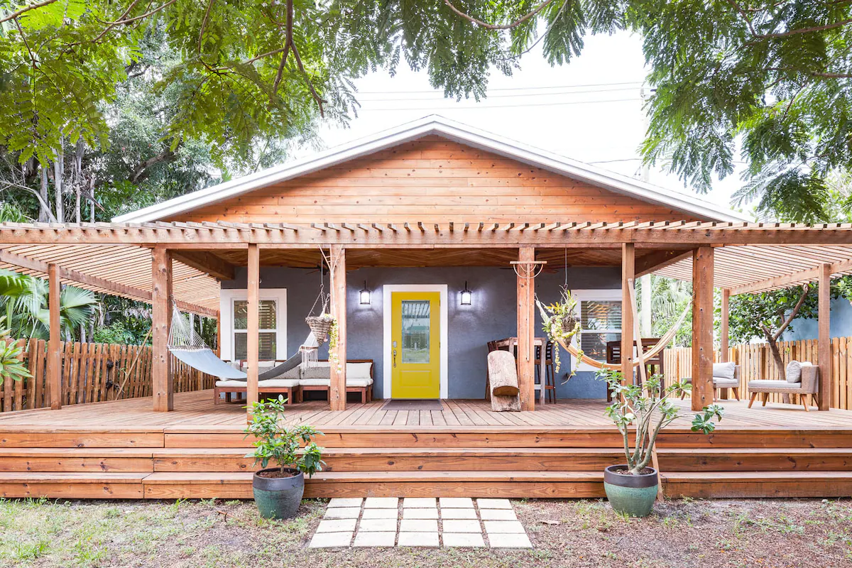 A single family home with a wide front porch in Wilton Manors, Florida.